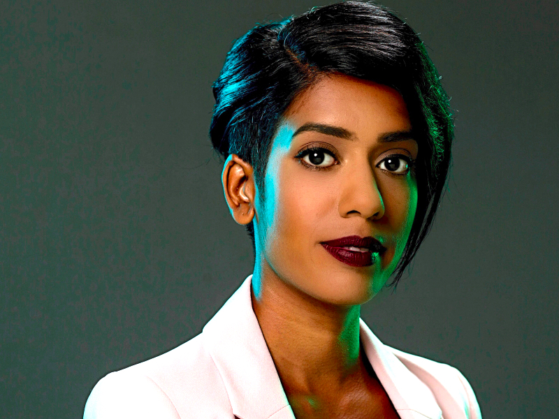 Headshot of Sheree Atcheson, a Sri Lankan woman with short black hair and a white jacket.