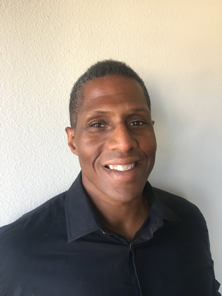 Headshot of Michael Thomas, an African-American man with short black hair