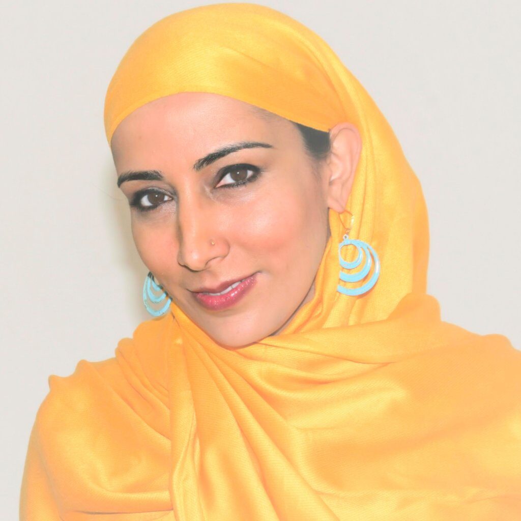 Headshot of Najeeba Syeed, a South Asian Muslim American woman wearing a yellow headscarf