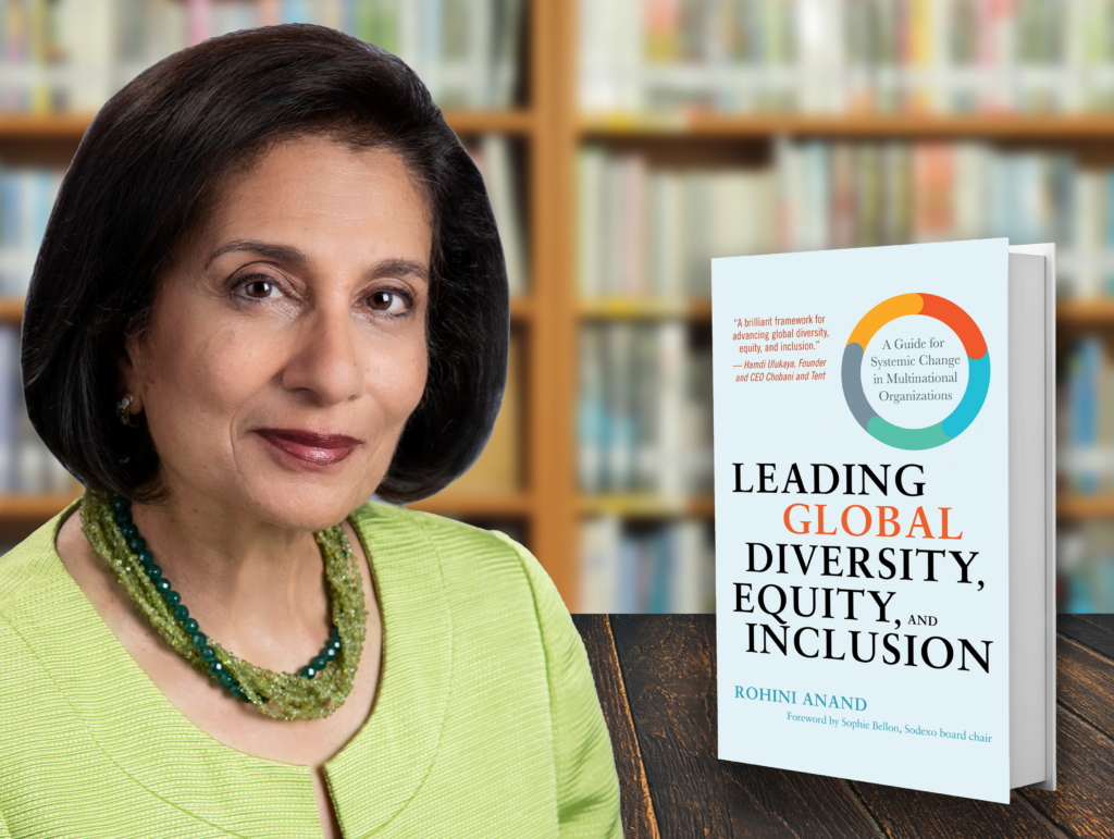 Headshot of Dr. Rohini Anand, an Asian American female with short black hair, an apple green dress, and an emerald-and-olive green beaded necklace; beside her is the grey book cover of Leading Global Diversity, Equity, and Inclusion: A Guide for Systemic Change in Multinational Organizations and a blurry bookshelf on the back.