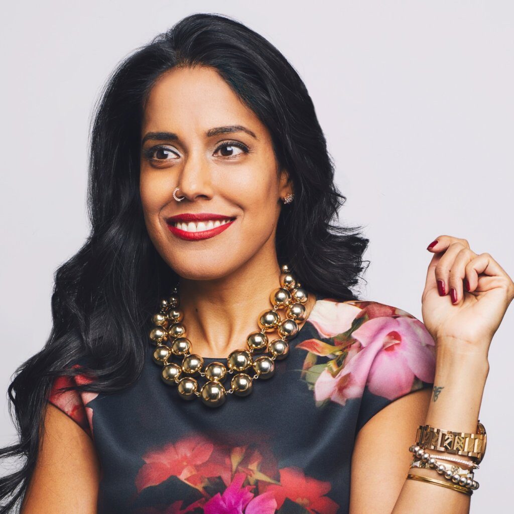 Headshot of Ritu Bhasin, a Punjabi Indian-Canadian woman with long black hair and beaded necklace